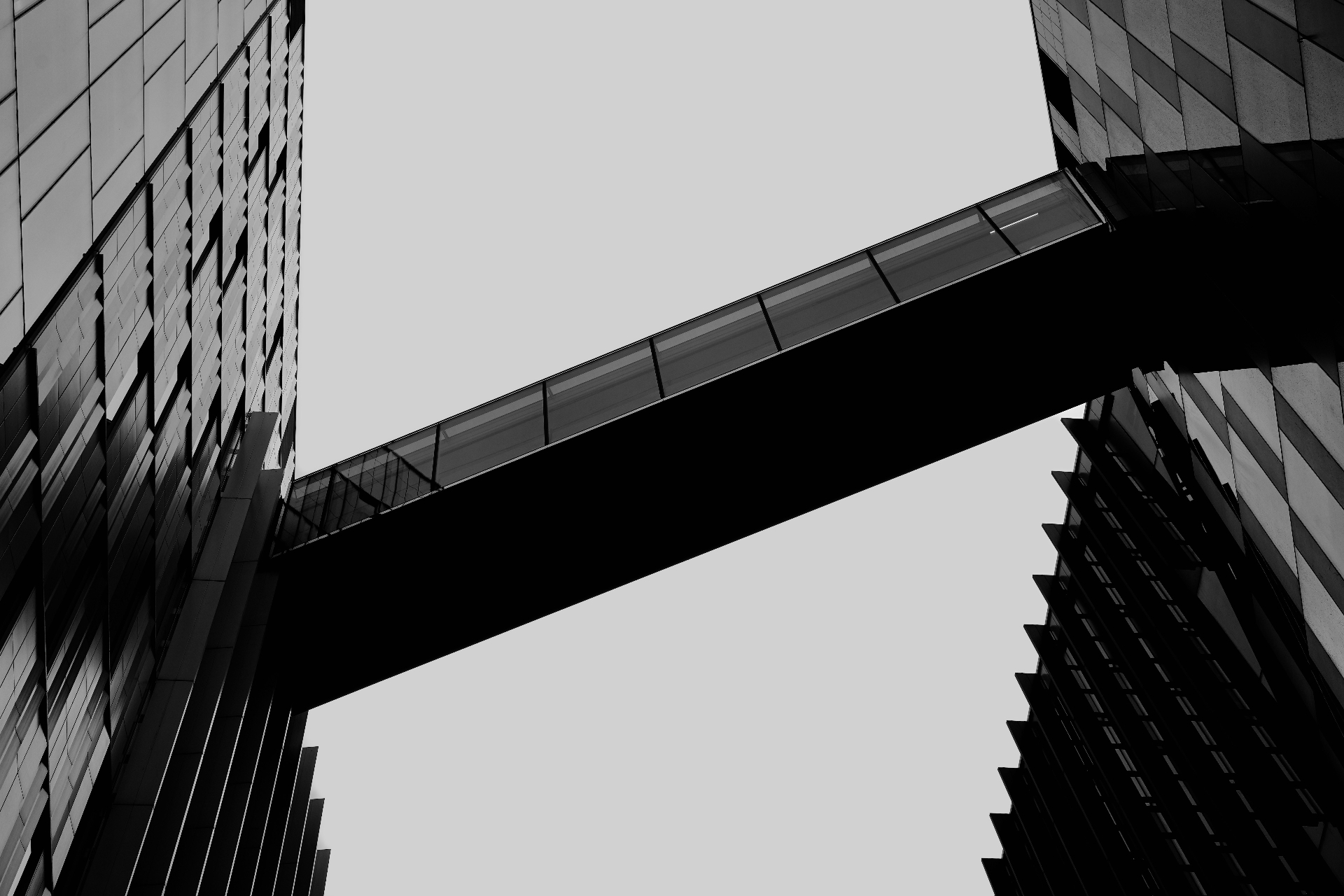 Architectural bridge between two modern buildings — symbolizing AETERNA's role as the bridge to a digital and global future